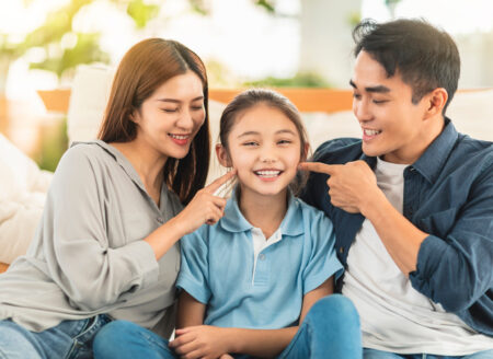 Happy family smiling  on the couch at home